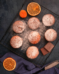 Chocolade muffins on cooling rack decorated on black background.Top view.