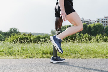Sport man with prosthetic leg warming up before exercise workout training outdoor - Fitness...
