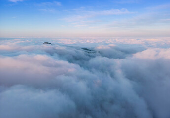 aerial vire of mountain top above the clouds. Ceahlau, Romania