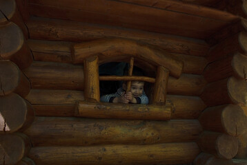 Obraz premium boy slides down the slide on the playground in the park