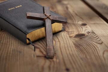 Religious wooden crucifix cross upright on wooden table background