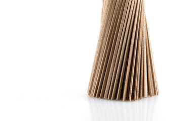 Buckwheat soba noodles in bunche, isolated on white background. Close-up. 