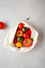 Organic homegrown heirloom tomato in cotton bag zero waste concept top view