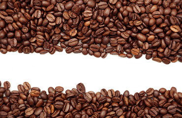 Closeup of roasted brown coffee beans on plain background. Copy space
