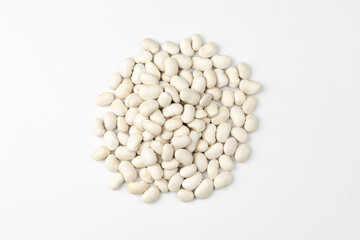 heap of white beans on white background, top view