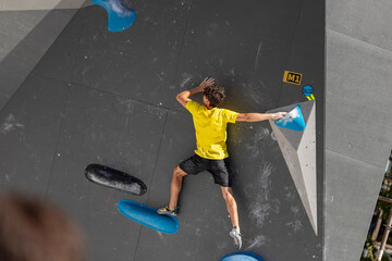 Climbing. Sport. Young person climbing in Block Climbing. Olympic exercise. Olympic Sport....