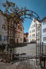 View in the old town of Ansbach. Iron gate in the shape of an arch with plants growing on it. Ansbach, Bavaria Region Middle Franconia, Germany