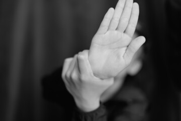 Black and white portrait of teenage boy on dark background. Low key close up shot of a young teen boy. Black and white photography. Selective focus