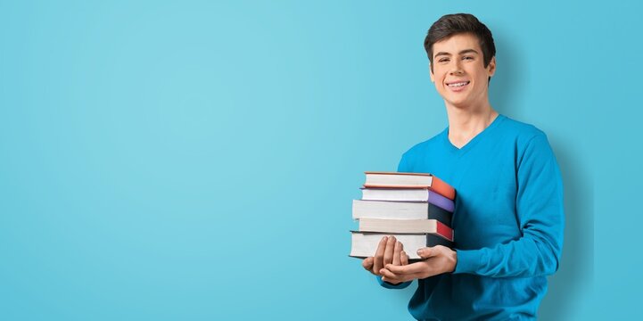 Young teenage student man posing