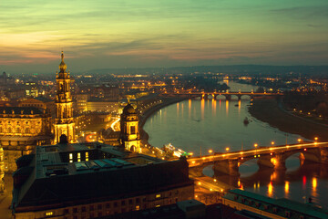 Fototapeta na wymiar Dresden am Abend mit Elbe, Gold leuchtend mit Brücken im Abendlicht mit Sonnenuntergang an der Elbe