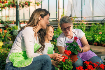 Three generation of florists enjoying work in the greenhouse and planting flowers