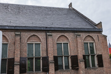 Intimate Chapel from 1390 with its beautiful arched windows and men's hall (Mannenzaal) behind it - remained from medieval building of St. Pieters en Bloklands Gasthuis. Amersfoort, the Netherlands.