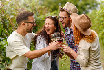 Happy friends having fun drinking wine at winery vineyard - Friendship concept with young people...