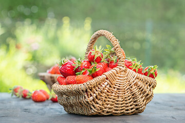 Fototapeta na wymiar Strawberries in a basket on a wooden table