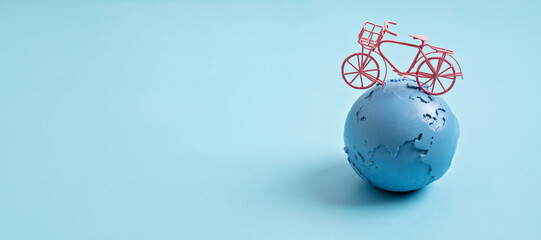 Globe and bicycle. Save the planet idea. International Earth Day. World Bicycle Day. Environmental problems and protection. Caring for Nature