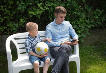 The boy calls his father for a walk. But father is busy on the phone