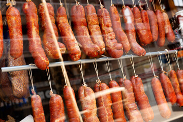 Dry cured traditional spanish sausage hanging in a store