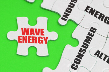 On a green surface are white puzzles with text, on a separate puzzle there is an inscription - wave energy