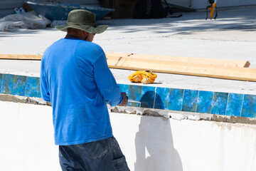 worker repairs swimming pool