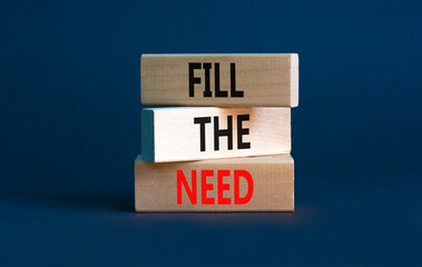 Fill the need symbol. Concept words Fill the need on wooden blocks on a beautiful grey table grey background. Business, finacial and fill the need concept. Copy space.