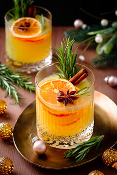 Winter warming bourbon old fashioned cocktail with oranges, cinnamon and rosemary