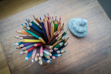 Obraz premium colored pencils and stack of rocks