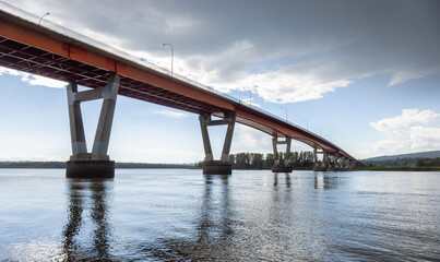 Mission Bridge over Fraser River during Sunny and Cloudy Spring Season Day. Fraser Valley, British Columbia, Canada.