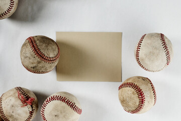 Vintage used baseballs on white background with copy space on note card for sports game concept.
