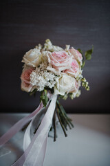 Wedding rings and bouquet on a background.