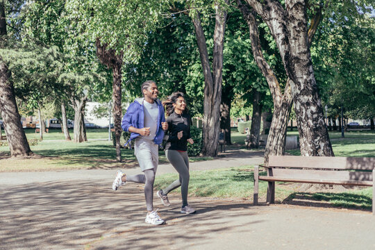 multi-ethnic runner couple joggin in park