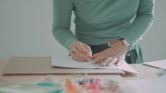 hands doing crafts on a table close up