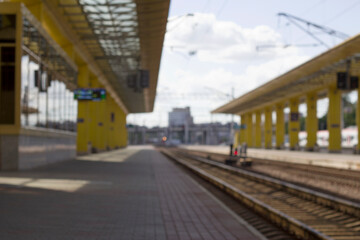Naklejka na ściany i meble unfocused train station in the city as a railway background