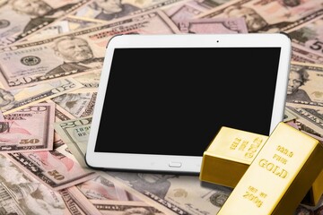 gold bars place on the phone and dollar. Fluctuations in gold prices concept.