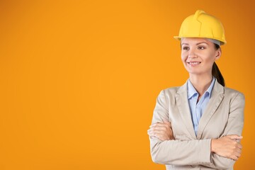 Young woman wearing architect hardhat against background