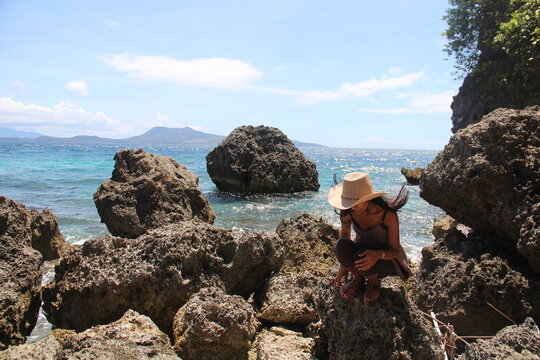 woman surrounded with lava rocks