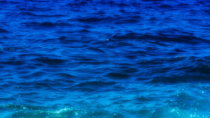 Sea water texture. Deep blue abstract background. Ocean water surface