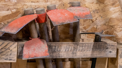Close up of Hoes, tool used to loosen the soil in the vegetable garden, stored, in a garden shed