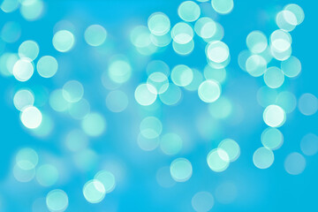 Glowing bokeh lights on a blue background. Backdrop for postcard business card design
