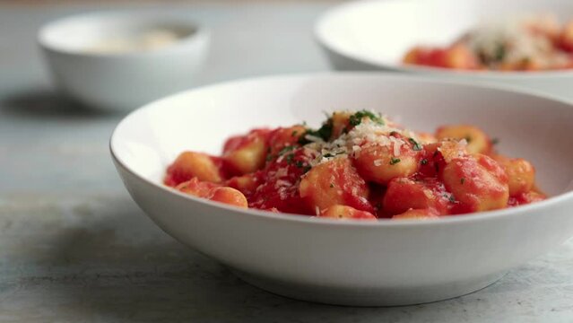 Gnocchi with tomato sauce and parmigiano on a plate