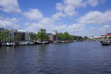 Gracht (town canal) in the city of Amsterdam on a sunny day
