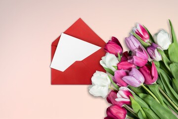 Fresh tulips, envelope with blank sheet. Valentine's Day, Mother's Day holiday concept.