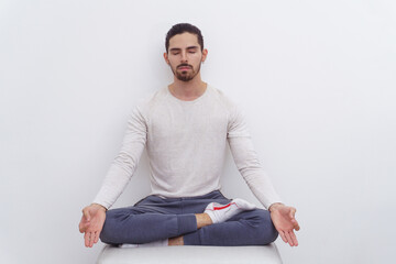 Man on a white background meditating