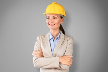 Studio portrait of a career lady or female engineer wearing a safety helmet