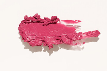 Cosmetics lipstick swatches. Peach, pink, red and coral toned styled cosmetics flat lay. Lipstick colour palette. Creative concept photo of cosmetics samples isolated on white background