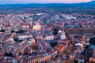 Aerial view of historic district of Vic town with ancient cathedral on winter twilight, Catalonia, Spain..