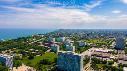 Chicago, IL USA June 5th 2022: Aerial drone view of a Chicago neighborhood downtown. the city beautiful architectural is also covered by lush green trees throughout the urban cityscape