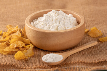Flour powder in wooden bowl and spoon 