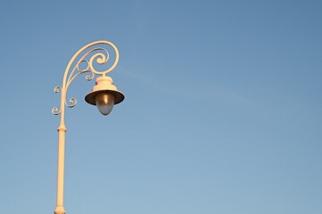 Fototapeta na wymiar Street light against blue sky at sunset. 