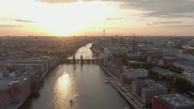 Berlin Cityscape Aerial Drone Shot over Spree River towards Oberbaum Bridge at Sunset