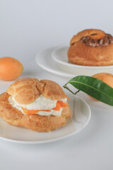 Delicious homemade choux pastry with custard and Marian Plum or Mayongchid. on white background